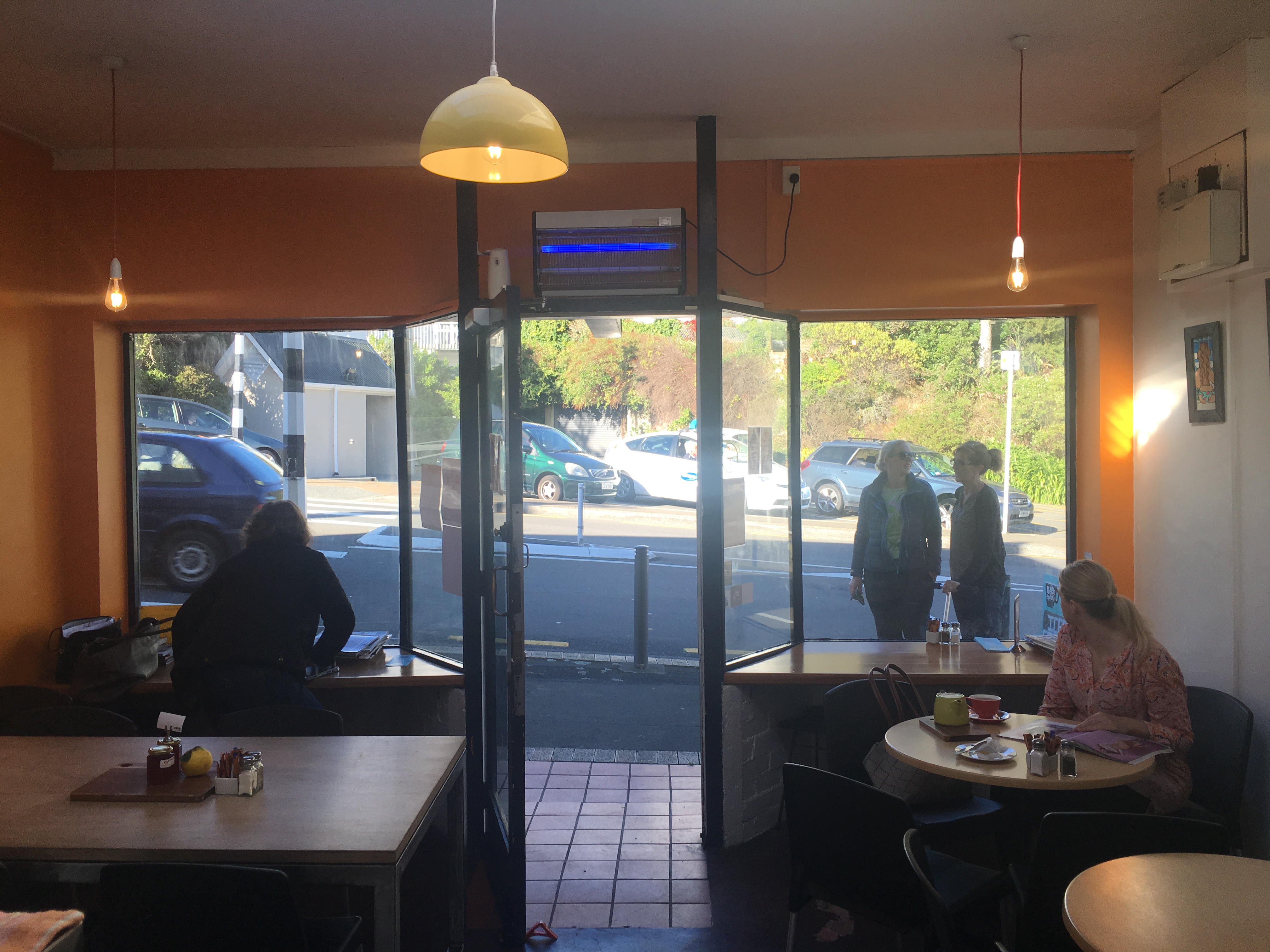 Inside Wadestown Kitchen — warm orange walls, cosy tables